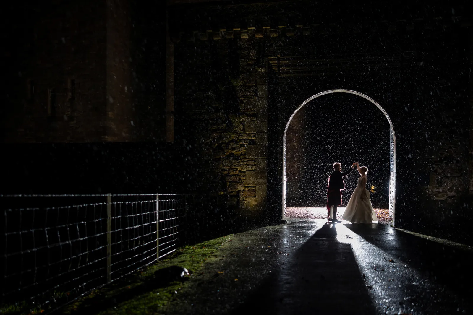 dancing in the rain borthwick castle wedding photo