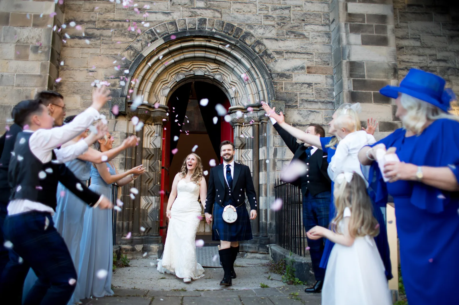 bride and groom walking through confetti edinburgh wedding photos at mansfield traquair venue in edinburgh